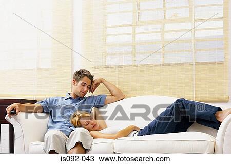 Couple resting on sofa View Large Photo Image Stock Image - Couple resting on sofa. Fotosearch