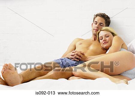 Couple sleeping on bed View Large Photo Image Stock Image - Couple sleeping on bed. Fotosearch