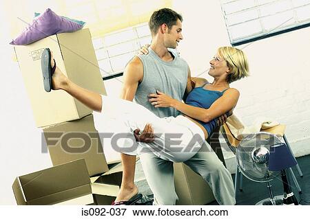 Man carrying woman playfully View Large Photo Image Stock Photo - Man carrying woman playfully. Fotosearch