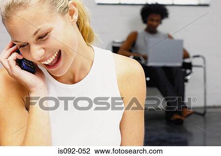 Young woman on her mobile telephone View Large Photo Image Stock Image - Young woman on her mobile telephone. Fotosearch