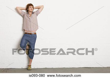 Stock Image - Man against wall. Fotosearch