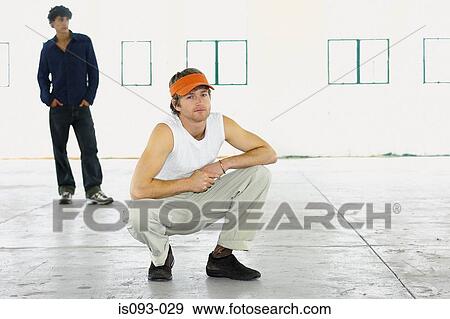 Man squatting View Large Photo Image Stock Photo - Man squatting. Fotosearch