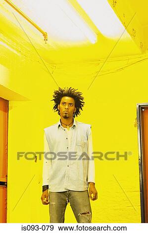 Man standing in yellow room View Large Photo Image Stock Photo - Man standing in yellow room. Fotosearch