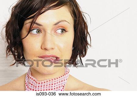 Stock Photograph - Woman biting lip. Fotosearch