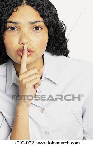 Woman placing finger on mouth View Large Photo Image Stock Image - Woman placing finger on mouth. Fotosearch