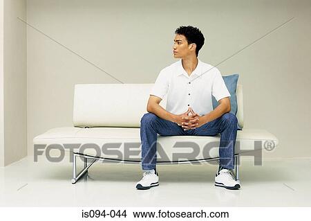 Picture - Man on modern sofa. Fotosearch