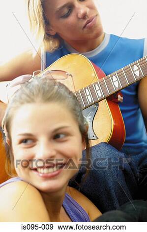 Teenage boy and girl playing the guitar View Large Photo Image Stock Photo - Teenage boy and girl playing the guitar. Fotosearch