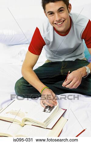 Teenage boy doing homework View Large Photo Image Stock Image - Teenage boy doing homework. Fotosearch