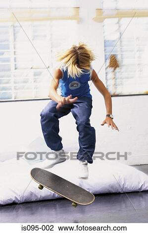 Teenage boy on skateboard View Large Photo Image Stock Image - Teenage boy on skateboard. Fotosearch