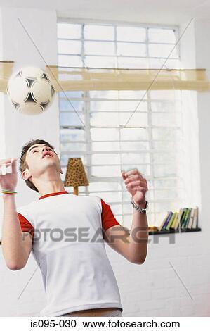 Stock Image - Teenage boy with football. Fotosearch