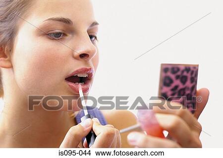 Picture - Teenage girl applying makeup. Fotosearch