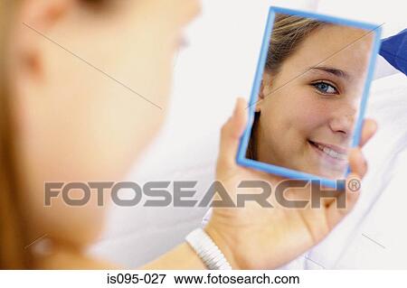 Teenage girl looking in mirror View Large Photo Image Stock Photo - Teenage girl looking in mirror. Fotosearch