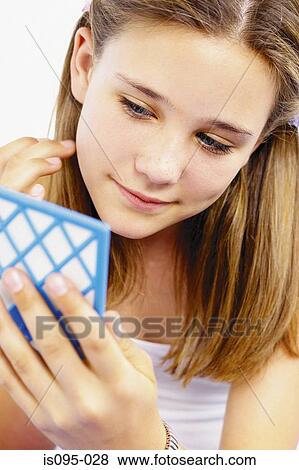 Teenage girl looking in mirror View Large Photo Image Stock Photo - Teenage girl looking in mirror. Fotosearch