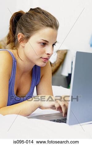 Teenage girl on laptop computer View Large Photo Image Picture - Teenage girl on laptop computer. Fotosearch