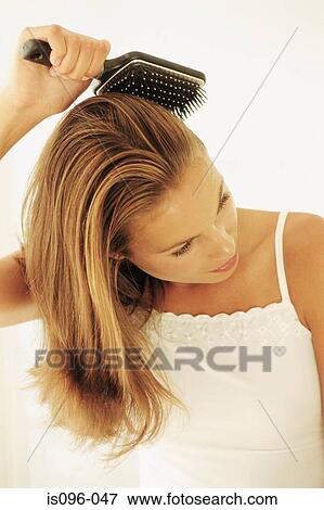 Woman brushing hair View Large Photo Image Stock Photo - Woman brushing hair. Fotosearch