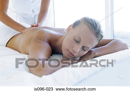 Woman receiving back massage View Large Photo Image Stock Image - Woman receiving back massage. Fotosearch