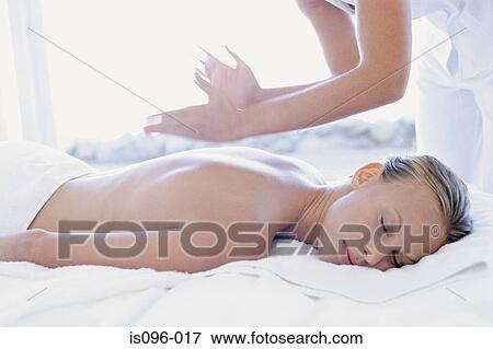 Woman receiving back massage View Large Photo Image Stock Photo - Woman receiving back massage. Fotosearch