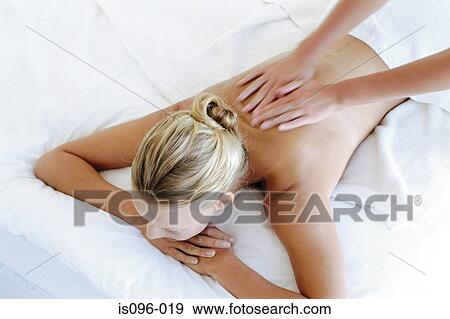 Woman receiving back massage View Large Photo Image Stock Photo - Woman receiving back massage. Fotosearch