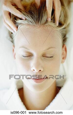 Stock Image - Woman receiving head massage. Fotosearch