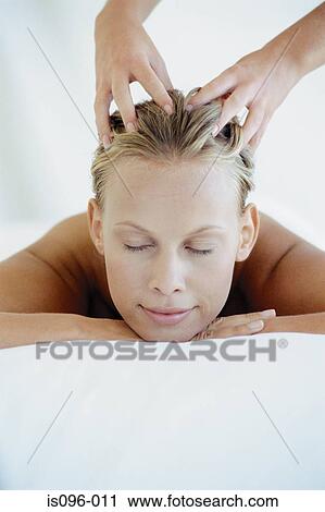 Stock Image - Woman receiving head massage. Fotosearch