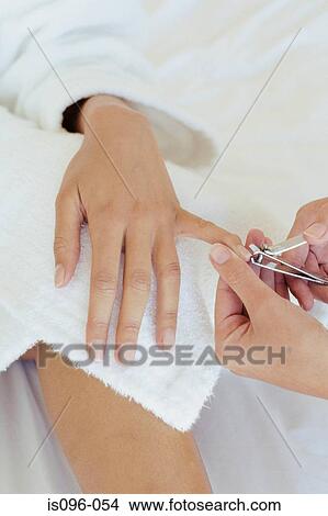 Woman receiving manicure treatment View Large Photo Image Picture - Woman receiving manicure treatment. Fotosearch