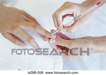 Woman receiving manicure treatment View Large Photo Image Stock Photo - Woman receiving manicure treatment. Fotosearch