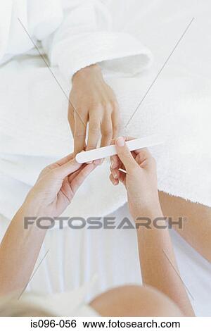 Woman receiving manicure treatment View Large Photo Image Stock Photograph - Woman receiving manicure treatment. Fotosearch