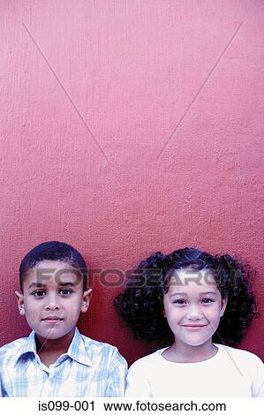 Stock Image - Boy and girl against wall. Fotosearch