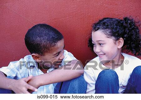 Boy and girl against wall View Large Photo Image Stock Photography - Boy and girl against wall. Fotosearch