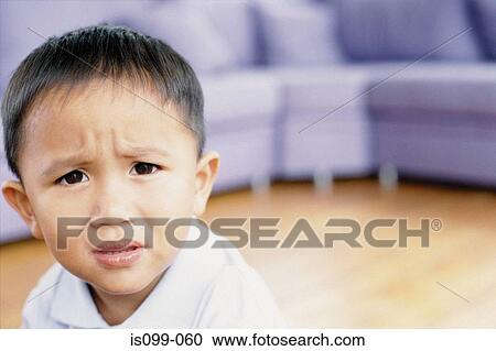 Stock Image - Boy looking worried. Fotosearch