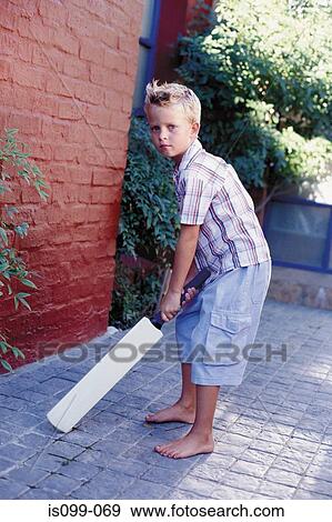 Stock Photo - Boy playing cricket. Fotosearch