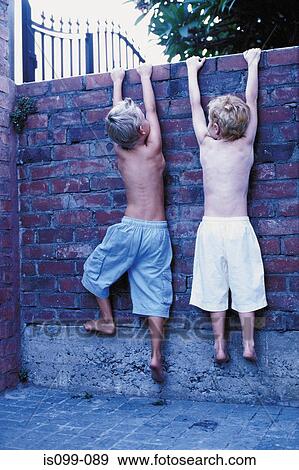 Boys climbing wall View Large Photo Image Stock Photo - Boys climbing wall. Fotosearch