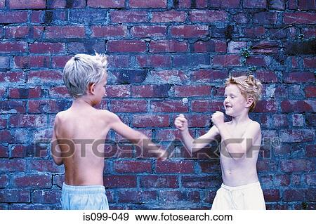 Boys fighting against wall View Large Photo Image Stock Photo - Boys fighting against wall. Fotosearch