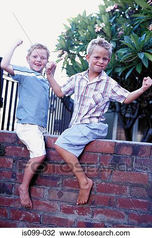 Boys playing on wall View Large Photo Image Stock Image - Boys playing on wall. Fotosearch