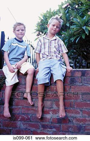 Boys sitting on wall View Large Photo Image Stock Image - Boys sitting on wall. Fotosearch