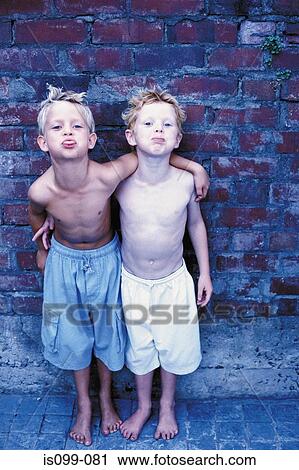 Boys standing against wall View Large Photo Image Stock Image - Boys standing against wall. Fotosearch