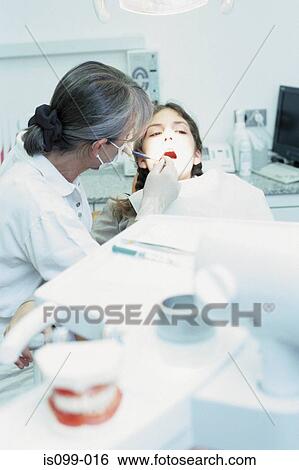 Girl being examined by dentist View Large Photo Image Stock Photograph - Girl being examined by dentist. Fotosearch