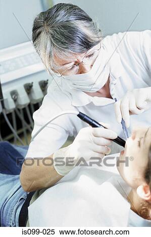 Girl being examined by dentist View Large Photo Image Stock Photography - Girl being examined by dentist. Fotosearch