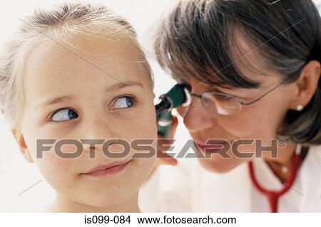 Girl being examined by doctor View Large Photo Image Picture - Girl being examined by doctor. Fotosearch