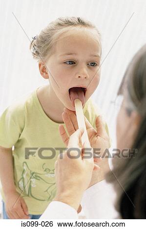 Stock Photograph - Girl being examined by doctor. Fotosearch