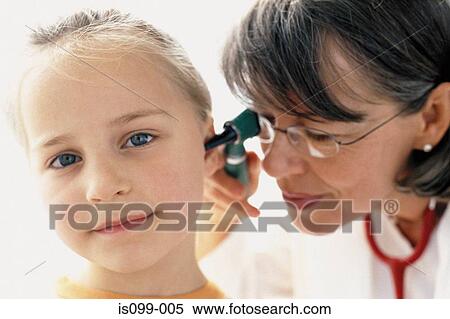 Stock Photography - Girl being examined by doctor. Fotosearch