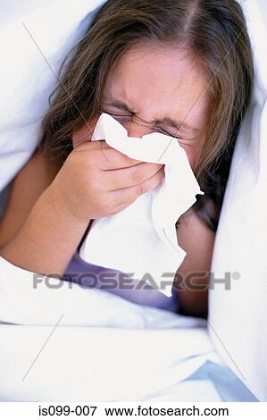 Girl blowing nose View Large Photo Image Stock Photo - Girl blowing nose. Fotosearch