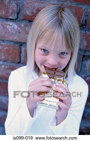 Girl eating chocolate View Large Photo Image Stock Photo - Girl eating chocolate. Fotosearch