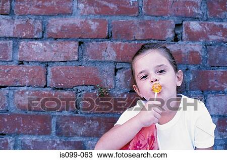 Girl eating lollipop View Large Photo Image Stock Image - Girl eating lollipop. Fotosearch