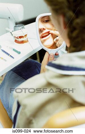 Girl examining her teeth View Large Photo Image Picture - Girl examining her teeth. Fotosearch