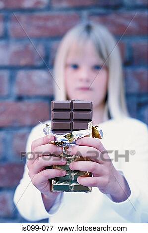 Girl offering chocolate View Large Photo Image Stock Photo - Girl offering chocolate. Fotosearch