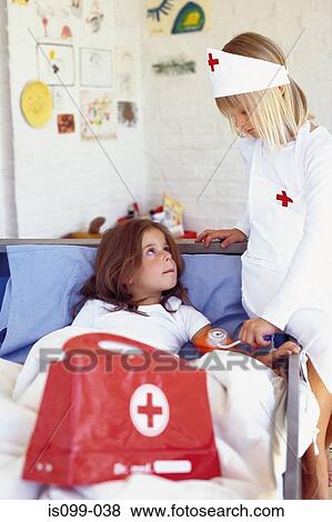 Girls playing doctor View Large Photo Image Stock Photo - Girls playing doctor. Fotosearch