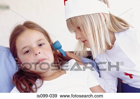 Girls playing doctor View Large Photo Image Stock Photo - Girls playing doctor. Fotosearch