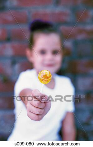 Portrait of a girl offering flower View Large Photo Image Stock Image - Portrait of a girl offering flower. Fotosearch