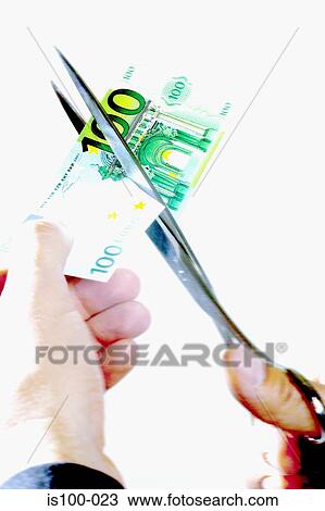 Stock Image - Cutting a banknote. Fotosearch
